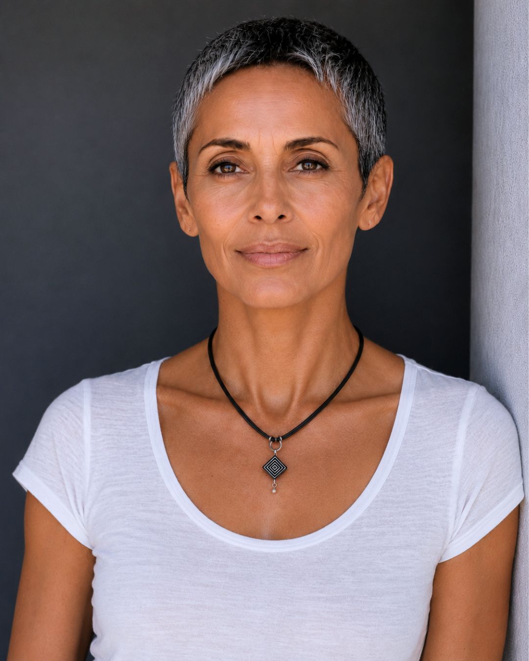 Woman wearing a handcrafted contemporary ostrich eggshell pendant necklace designed for elegant everyday wear.